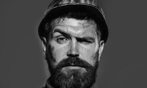 Builder man. Bearded builder, foreman or architect in protective hard hat, cl Stock Photos