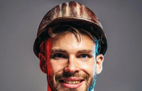 Builder man. Handsome architect, builder or civil engineer in hard hat. Indus Stock Photos