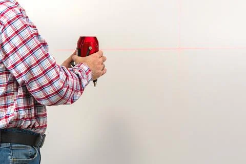 Builder man with   laser level on  isolated background 写真素材