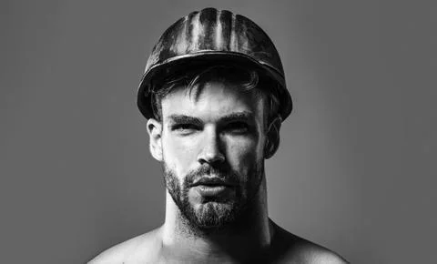 Builder man. Serious builder, foreman or architect in protective hardhat, c.. Stock Photos