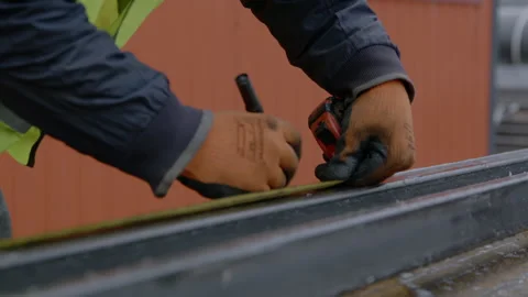 Builder measures and marks beam at construction site Stock Footage 255295972