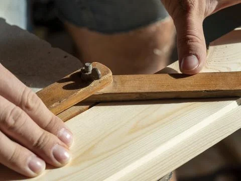 The Builder measures the desired angle using a special tool. Close-up Stock Photos