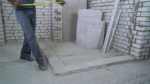 Builder measures distances with measuring tape at construction site Stock Footage 102115902