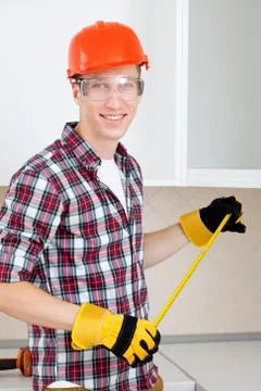 Builder measures the length Stock Photos