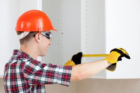 Builder measures the length Stock Photos