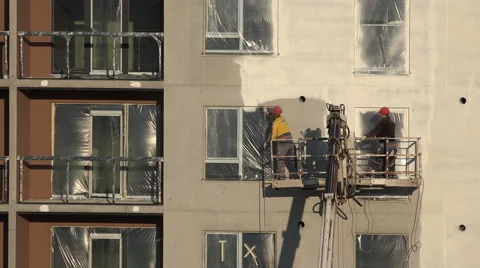 Builder men paint house wall with sprayer tool. 4K Stock Footage 50303186