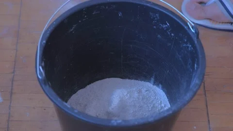Builder mixing cement plaster in bucket using an electric mixer, closeup view. Stock Footage 152961693