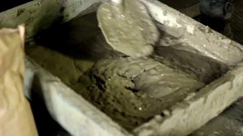 Builder mixing concrete for construction Stock Footage 71184879