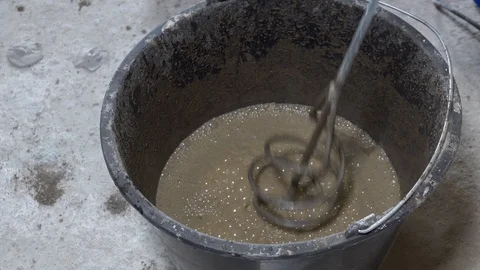 The builder is mixing concrete with plaster, apartment repair Stock Footage 115419342