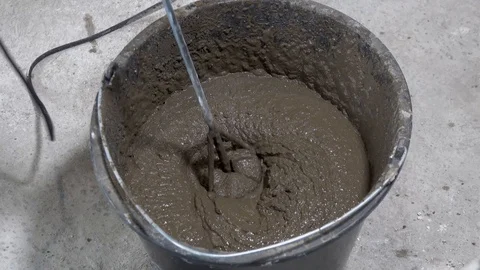 The builder is mixing concrete with plaster, apartment repair Stock Footage 115419453