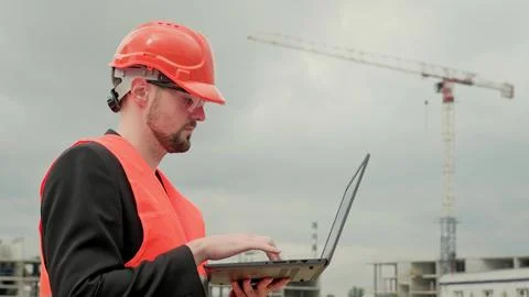 Builder with modern gadget at construction site Stock Photos