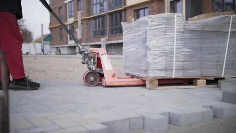 A builder moves paving slabs on a trolley Stock Footage 165821198