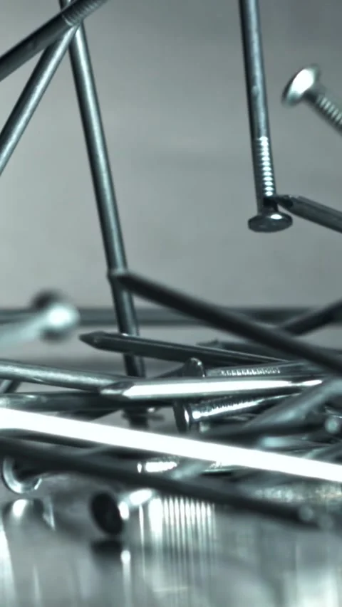 Builder nails scatter carpentry macro composition Filmed on a high-speed camera Stock Footage 335396159