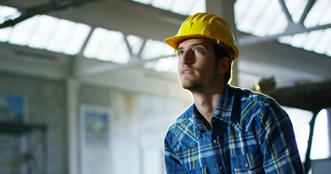 Builder or architect controls design construction of building on site.  Vídeos de archivo 115392443