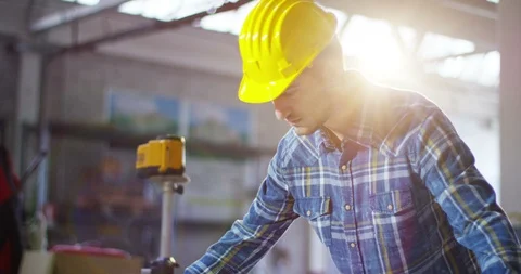 Builder or architect controls design construction of building on site.  Vídeos de archivo 115392481