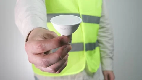 A builder or engineer demonstrates a light bulb. Video stock 312169398