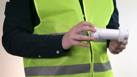 A builder or engineer holds pipes in his hands Stock-Footage 312169384