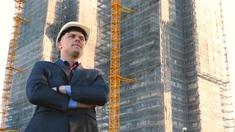 Builder or engineer, stands with his back looking at the buildings Stock Photos