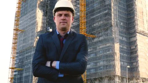 Builder or engineer, stands with his back looking at the buildings Stock Photos