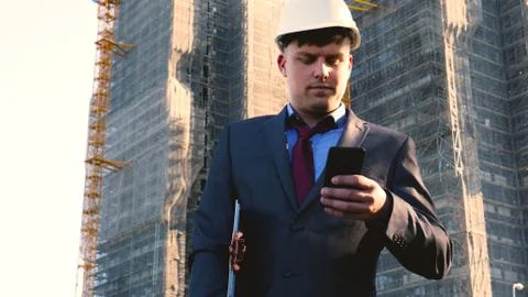 Builder or engineer, stands with his back looking at the buildings Stock Photos