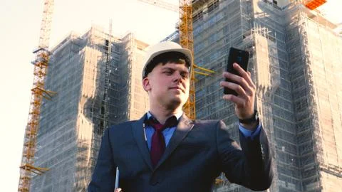Builder or engineer, stands with his back looking at the buildings Stock Photos