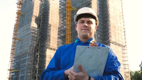 Builder or engineer, stands with his back looking at the buildings Stock-Fotos