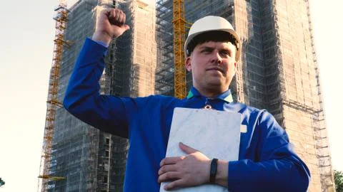 Builder or engineer, stands with his back looking at the buildings Stock-Fotos