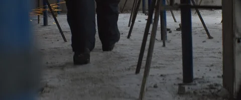 Builder or worker in uniform goes through sheaf of sparks in order to sit down Stock Footage 119496862