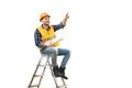 The builder with a paper on the ladder gesturing on the white background Photo