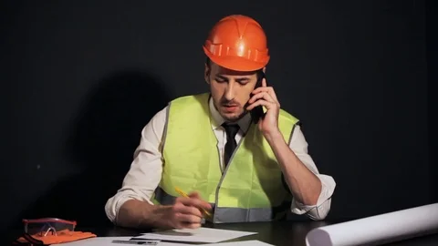 The Builder on the phone and writes the document Stock-Footage 81268290