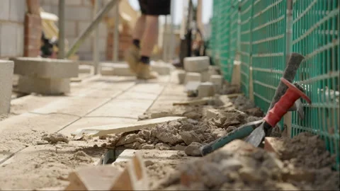 Builder Picks Up Tools On Building Site Video stock 239754136