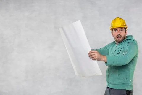 Builder with plans, copy space next Stock Photos