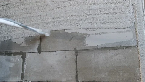 Builder Plasterer Applies Plaster to Wall with Special Sprayer. Spray Gun. Work Stock Footage 168355980