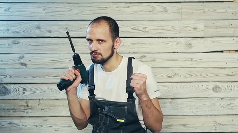 Builder is playing with a screwdriver Stock Footage 82974188