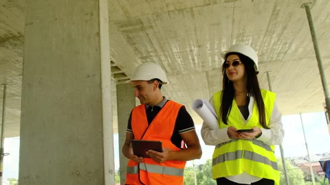 Builder points to structures walking near inspector Video stock 317619744