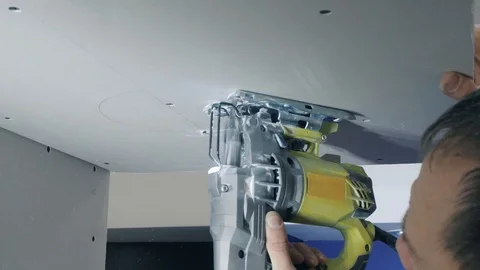 Builder polishes ceiling construction moving special machine Stock Footage 124607997