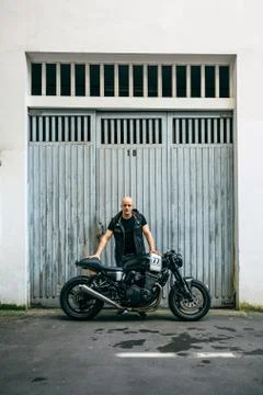 Builder posing with a motorcycle Stock Photos