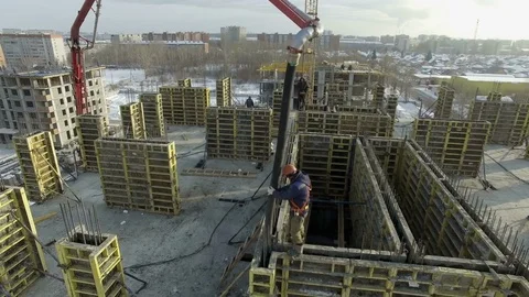 Builder pours cement between the walls with the hose Stock Footage 82014804