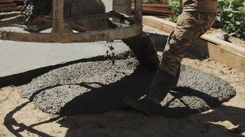 A builder pours a concrete foundation Stock Footage 287634267