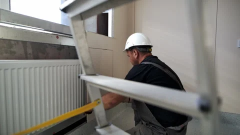 Builder prepares to attach chipboard panel to room wall Stock Footage 280911022