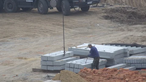 Builder prepares concrete beams for a crane Stock Footage 120675113