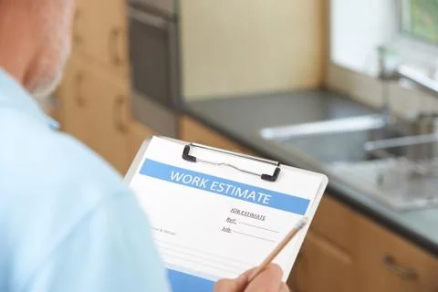 Builder Preparing Estimate For Home Improvement Stock Photos