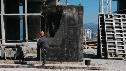 Builder is preparing a panel for installation at a construction site. Video stock 127218783