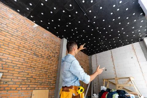 Builder projecting future interior standing at the construction site 스톡 사진