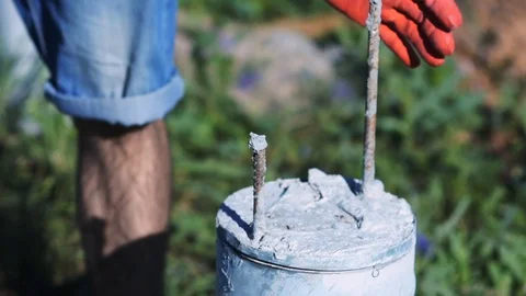 Builder pulls out rebar from the concrete pillar 動画素材 72599444