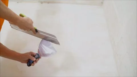 The builder put mortar on the wall. Plaster walls. Exterior finish. Putting m Stock Photos