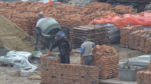 The builder puts a brick wall. the builder builds a brick wall. Stock Footage 120674719