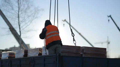 Builder puts on building bricks crane Video stock 63169684