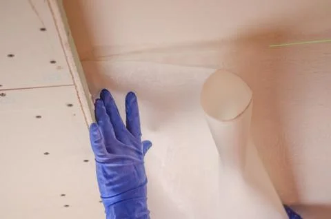The Builder puts plaster on the wall.Hand holding a spatula with construction Stock Photos