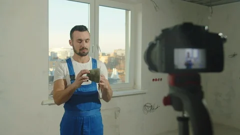 Builder puts on protective mask and talks on camera Stock Footage 124845097